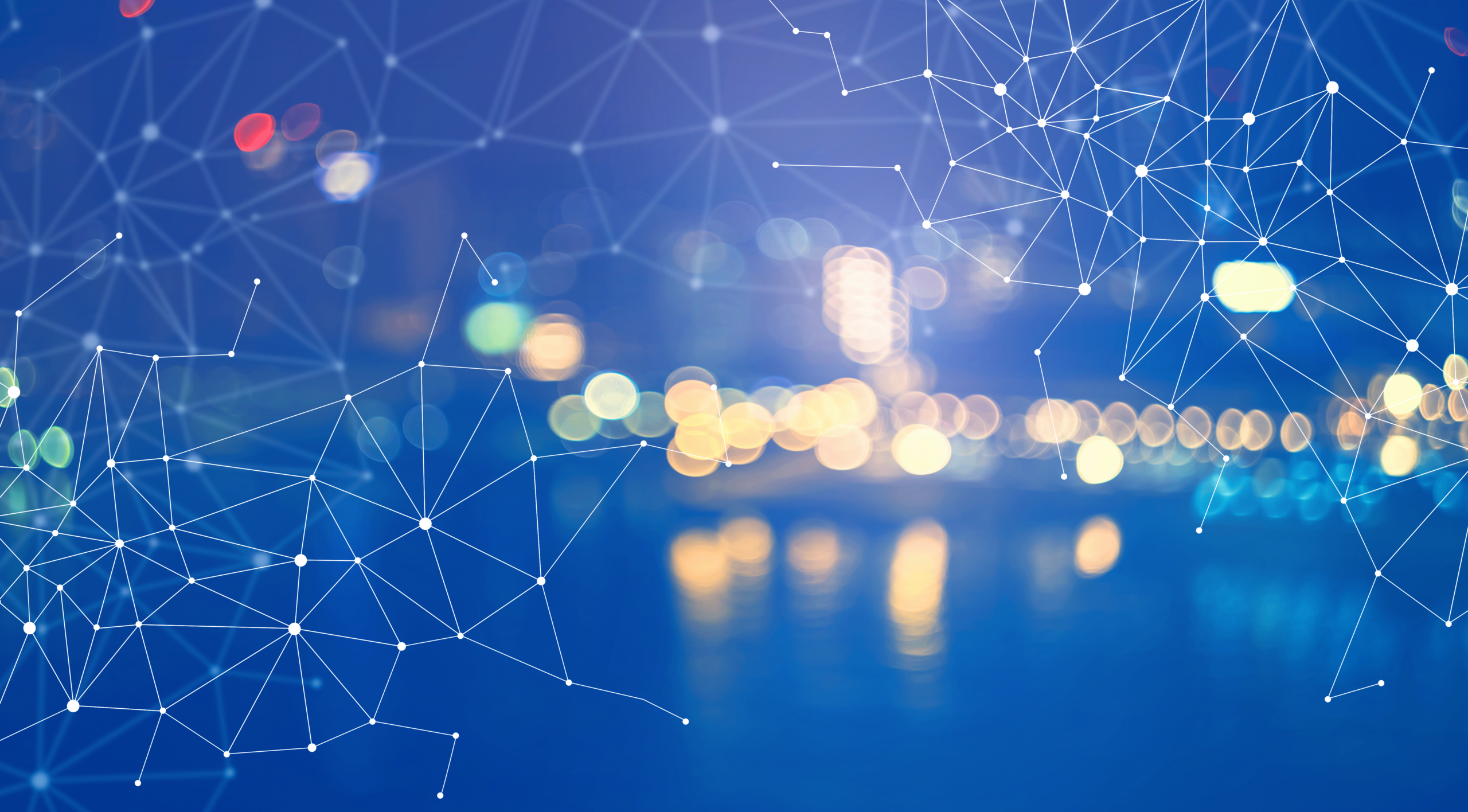 City skyline at night with digital network mesh overlay